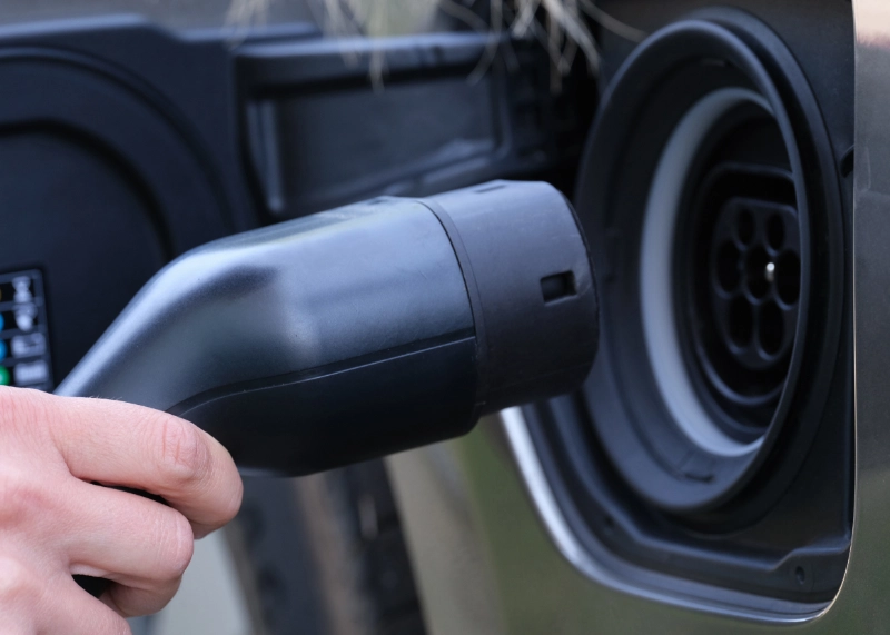 EV charger being plugged into an electric vehicle